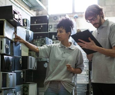 african-american-female-worker-reading-labels-while-male-coworker-taking-inventory-in