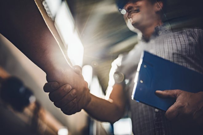 close-up-of-inspector-shaking-hands-with-unrecognizable-person-in-a-factory_enhanced (1)